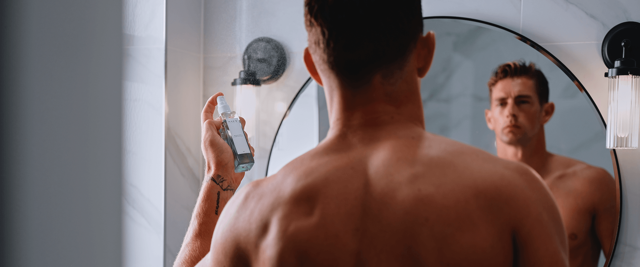 Man using sea salt spray for hair